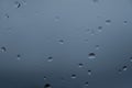 Rain water drops on glass over blurred blue background,abstract texture pattern Royalty Free Stock Photo