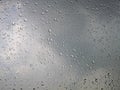 Rain water drops on gray sky background Royalty Free Stock Photo