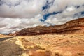 Rain water gathering by the highway near the desert landscape with rolling hills, AZ, USA