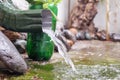 Rain water is pouring from the green draining gutter Royalty Free Stock Photo