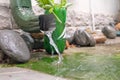 Rain water is pouring from the green draining gutter Royalty Free Stock Photo