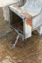 Rain water from rusty downspout Royalty Free Stock Photo