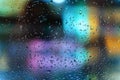 Rain on the window and bokeh city lights. Rainy night in the urban street at night. Seasons, weather concept. Selective Royalty Free Stock Photo