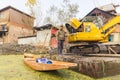 An excavator on a barge in Dal Lake