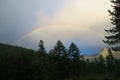 Rainbow above the forest in the mountains. Altai Mountains, Russia Royalty Free Stock Photo