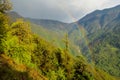 Rainbow above the green valley and mountain forest landscape Royalty Free Stock Photo