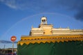 Rainbow above the marketplace near stopsign