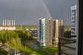 Rainbow above Moscow city, Russia in summer. Colorful rainbow over roofs of the multi-storey houses and trees after rain and cloud Royalty Free Stock Photo