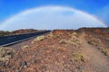 Rainbow above mountain volcano road. Volacano Pico del Teide, National Park, Tenerife, Canary Islands, Spain Royalty Free Stock Photo