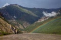 Rainbow above the muddy river in the mountains. Royalty Free Stock Photo