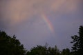 Rainbow above the village in the forest Royalty Free Stock Photo