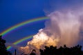 rainbow appears in the sky after the rain and back on sunset cloud Royalty Free Stock Photo