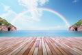 Rainbow arches over the sea, enhancing the wooden tabletops charm Royalty Free Stock Photo