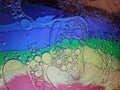 Rainbow background with bubbles, texture of water and oil drops Royalty Free Stock Photo