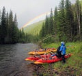 Rainbow on the background of wild nature of the Altai, coniferous forests and the valley of the Bashkaus river. Summer landscape