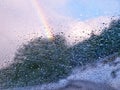 Rainbow behind car window glass with rain drops. After rain concept. Selective focus on window glass Royalty Free Stock Photo