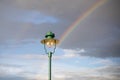 rainbow behind a street pole lamp