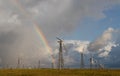 Rainbow behind wind turbines Royalty Free Stock Photo