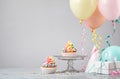 Rainbow Birthday Cupcakes with Balloons Royalty Free Stock Photo
