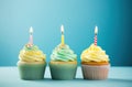 rainbow birthday cupcakes on blue background Royalty Free Stock Photo
