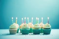 rainbow birthday cupcakes on blue background Royalty Free Stock Photo