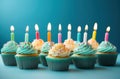 rainbow birthday cupcakes on blue background Royalty Free Stock Photo