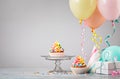 Rainbow Birthday Cupcakes at a Party with Colorful Balloons Royalty Free Stock Photo