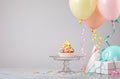 Colorful Birthday Cupcake with Balloons and party hats Royalty Free Stock Photo
