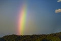 Rainbow with blue sky and mountain range