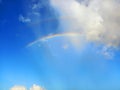 Rainbow in blue sky. Rainbow white clouds and tropical blue sky. Spectacular sky with white clouds and rainbows.