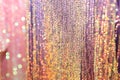 Rainbow blurred background, gold, pink and multicolored sequins on the fabric