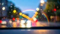 Rainbow and Bokeh Lights Through a Rainy Windshield Royalty Free Stock Photo
