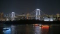Rainbow bridge and ships with Tokyo tower at night, Japan Royalty Free Stock Photo