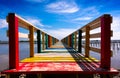 Rainbow bridge in Thailand.View of The colorful wood bridge extends into the sea under blue sky at samut sakhon province,Thailand