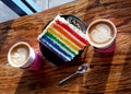 Rainbow Cake with Sprinkles and Cappuccinos Royalty Free Stock Photo