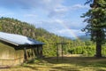 A rainbow can be seen in the distance from a small rural cabin in North Idaho