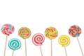 Rainbow candy lollipop on stick isolated in white. Royalty Free Stock Photo