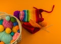 Rainbow cap made of wool on an orange background Royalty Free Stock Photo