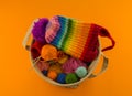 Rainbow cap made of wool on an orange background Royalty Free Stock Photo