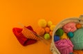 Rainbow cap made of wool on an orange background Royalty Free Stock Photo