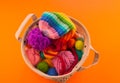 Rainbow cap made of wool on an orange background Royalty Free Stock Photo