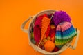 Rainbow cap made of wool on an orange background Royalty Free Stock Photo