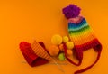 Rainbow cap made of wool on an orange background Royalty Free Stock Photo