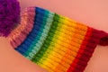 Rainbow cap made of wool on a pink background Royalty Free Stock Photo