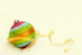 Rainbow Christmas ball with ribbon with free copy space background. Royalty Free Stock Photo