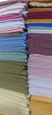 Rainbow clothes background. Pile of bright folded clothes. Royalty Free Stock Photo