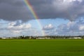 Rainbow in the cloudy sky over the flowerfields of Lisse. Royalty Free Stock Photo