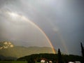 Rainbow in the cloudy sky over a small village Royalty Free Stock Photo