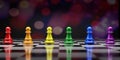 Rainbow color Chess pieces. Colorful chess pawns in a row on chessboard
