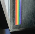 Rainbow color ribbon on dark sign